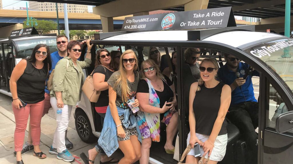 Group of women infront of City Tours MKE cruiser