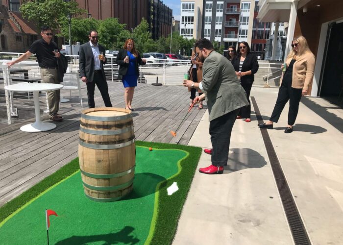 Corporate team playing mini golf together with CityToursMKE