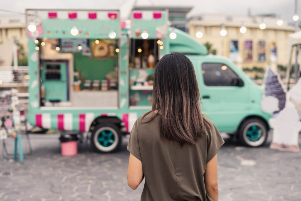 Woman infront of food truck in festival