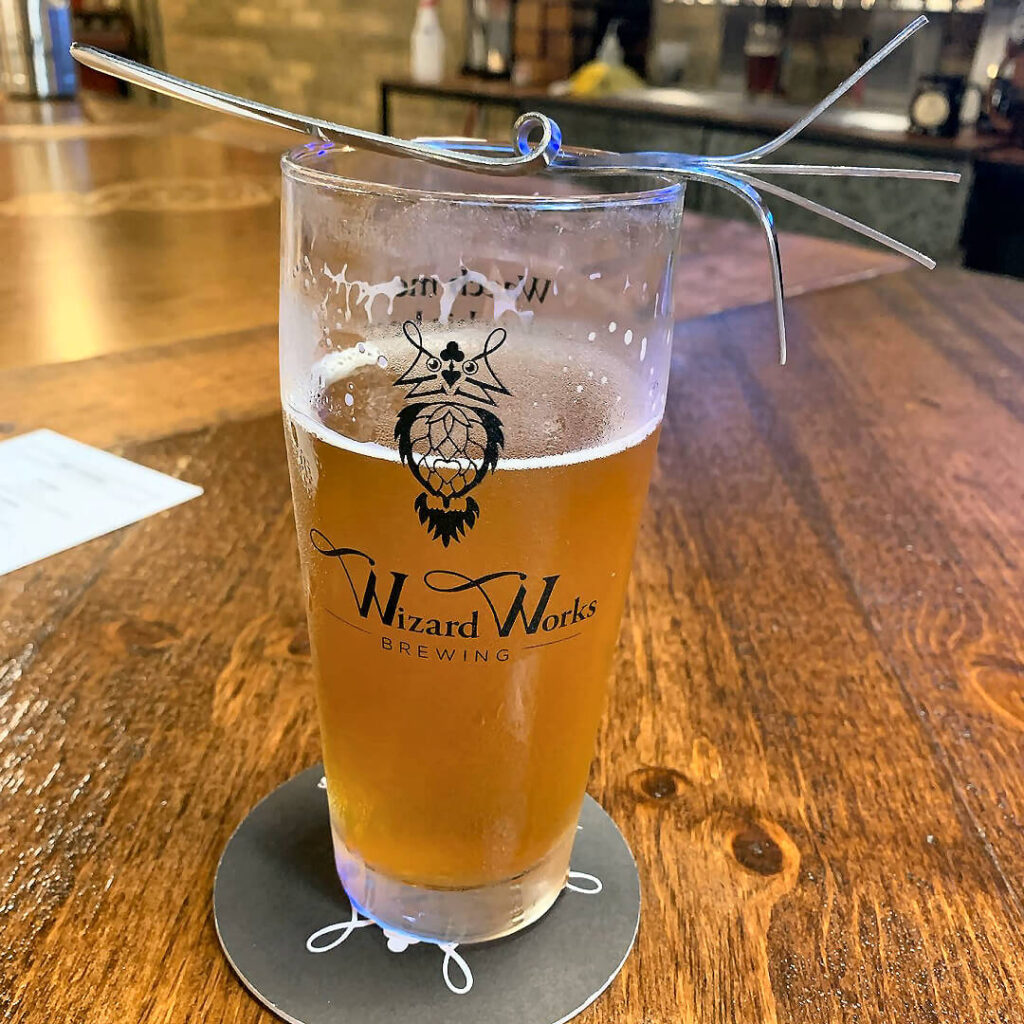 Wizard works brewing glass of beer on wooden table